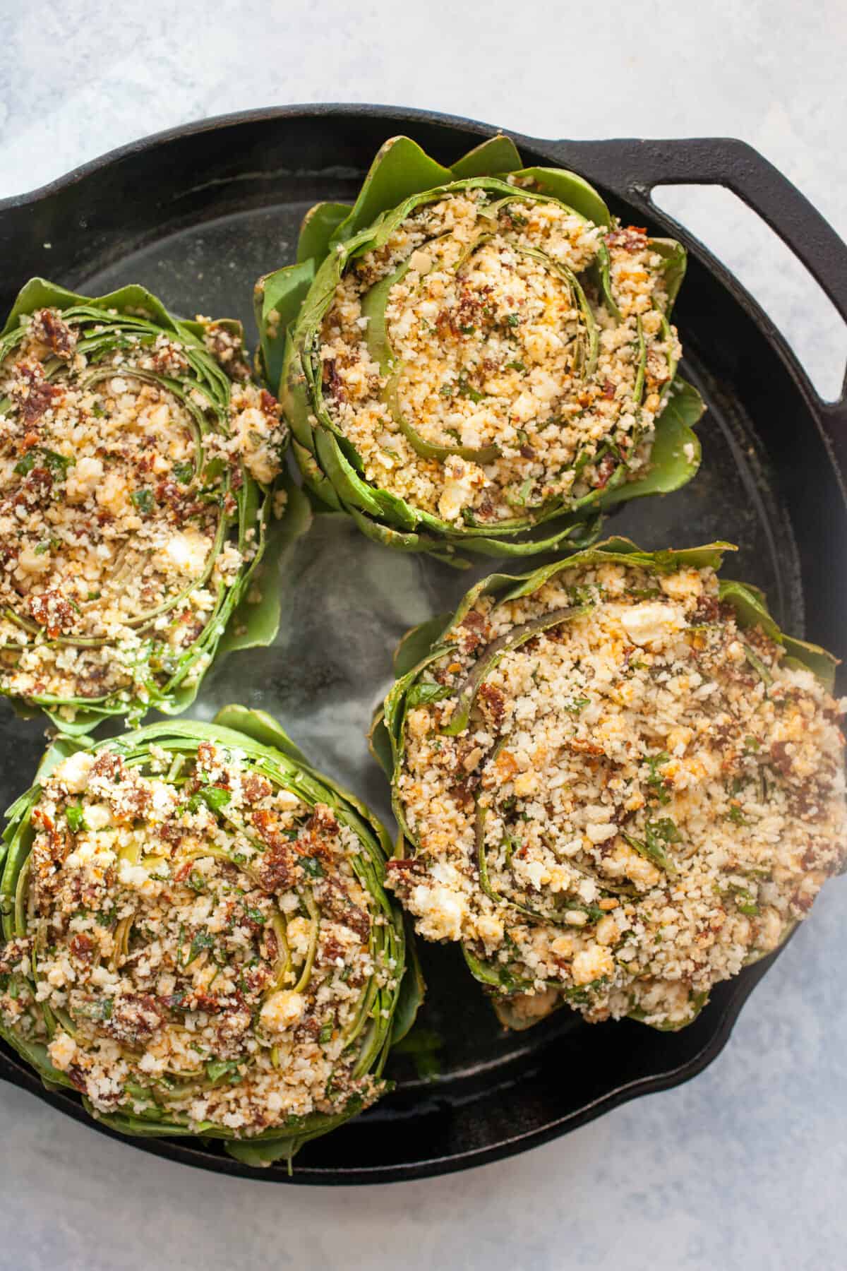 Stuffed Artichokes: These roasted artichokes are stuffed with a mix of delicious flavors like sun-dried tomatoes, feta, and basil. What a great appetizer! | macheesmo.com