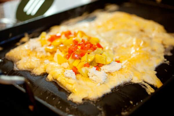 Filling the omelet on the griddle.