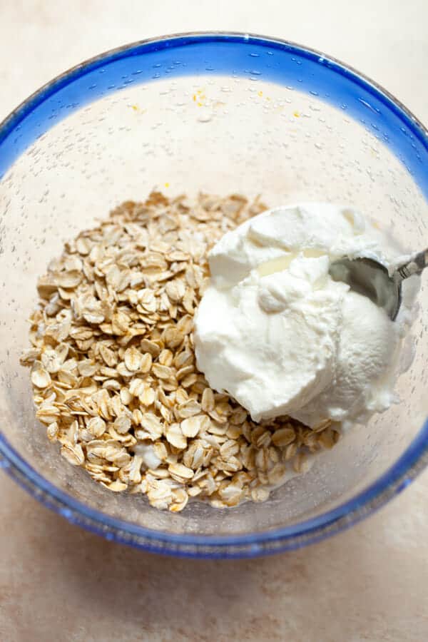 Rolled oats and yogurt in a bowl for muesli.