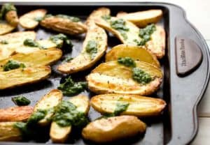 Roasted Fingerlings with Chive Pesto: Crispy roasted fingerling potatoes (they cook quickly) tossed with a simple chive pesto - packed with flavor! This is the side dish that potato lovers will have dreams about. | macheesmo.com