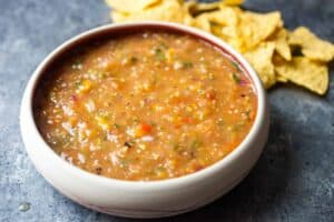 Easy grilled salsa with fresh tomatoes, tomatillos, onions, and sweet peppers. All charred on a grill and blended together. The best salsa you'll have this summer and easy to make!