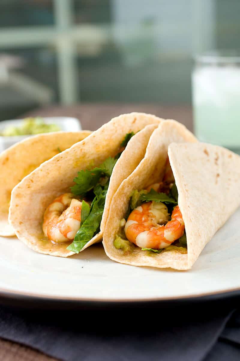 Margarita Shrimp Tacos: Tacos don't have to be heavy! These citrus and tequila marinaded shrimp are light and zesty and perfect for a fresh Tex-Mex dinner. Don't skimp on the guacamole! | macheesmo.com