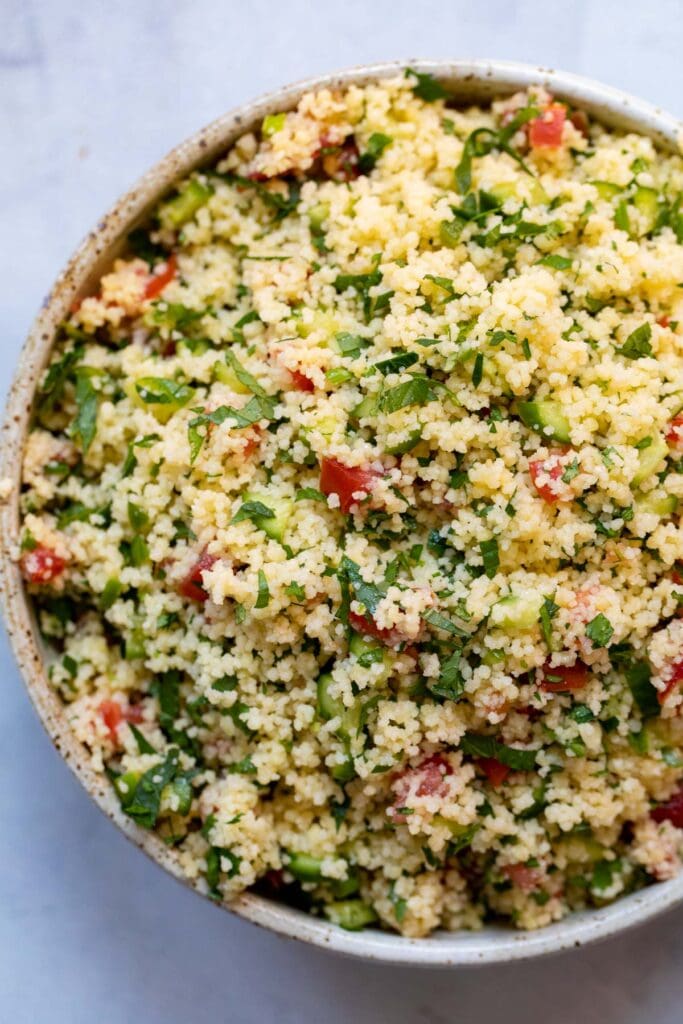 Couscous tabbouleh salad in a pretty bowl.