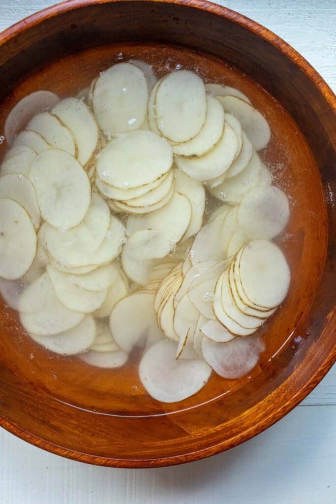 Rinsing potato chips in cold water.