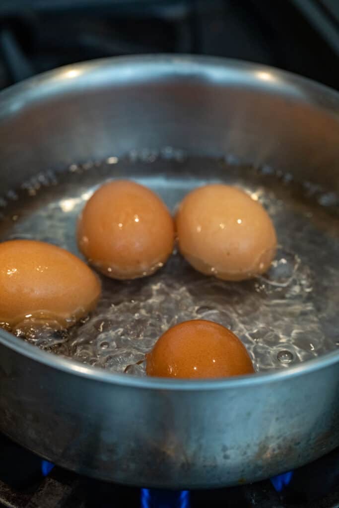 Simmering eggs in water.