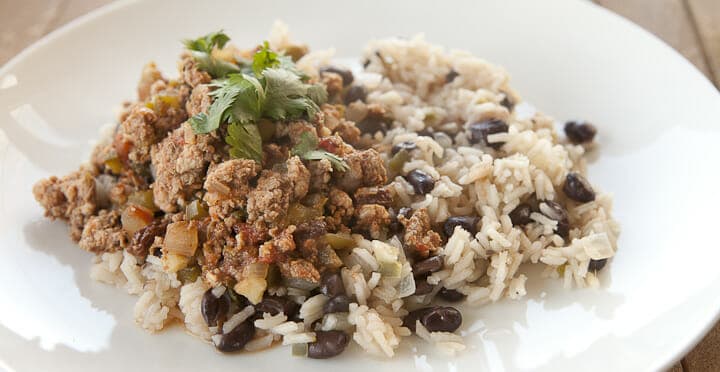 Classic Cuban Picadillo with ground beef and spices served over rice and black beans. A hearty plate of food to warm the soul!