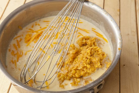 Adding cheese and corn to the corn souffle batter