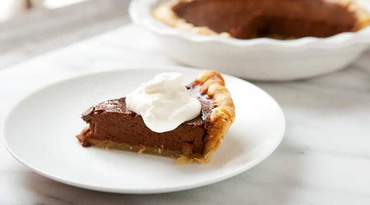 My version of Chef Symon's chocolate pumpkin pie made in a homemade all-butter crust. A really nice change on the classic pumpkin pie! macheesmo.com #pumpkinpie #chocolate #holiday #baking