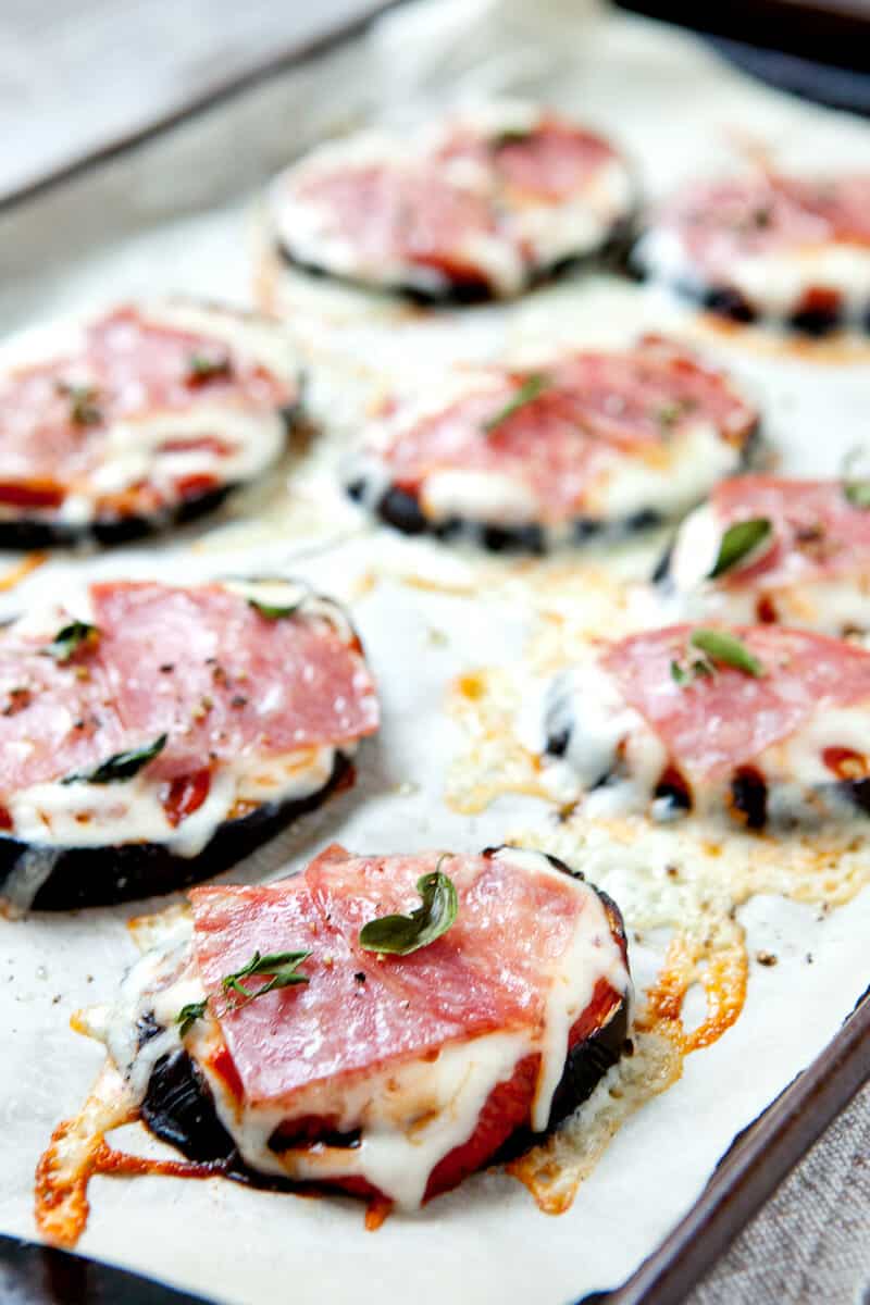Easy Eggplant Pizzas: Baked eggplant rounds topped with easy pizza toppings like cheese, pepperoni, and oregano. A great quick, warm snack! | macheesmo.com