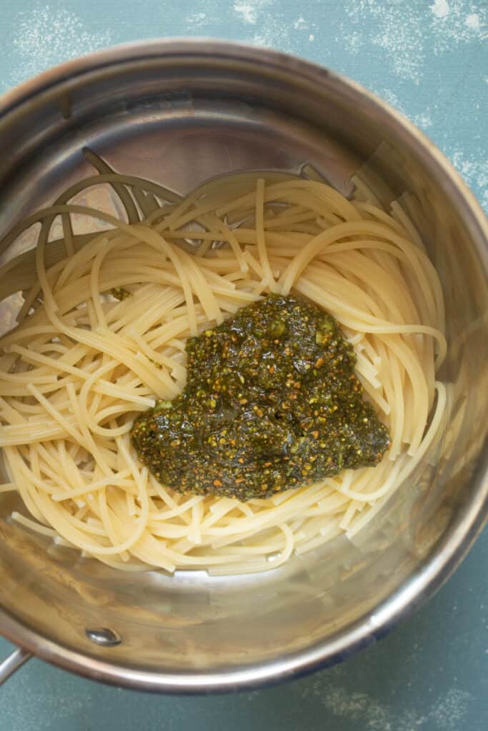 Pesto added to spaghetti. 