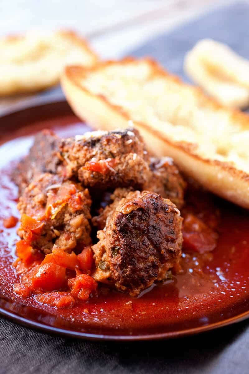 Easy Braised Meatballs: These delicious homemade braised meatballs are slow-simmered in tomatoes and red wine and so good served over pasta or with a crusty piece of bread. You could even make a sandwich out of them! | macheesmo.com