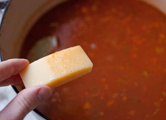 Adding parmesan to the stew.
