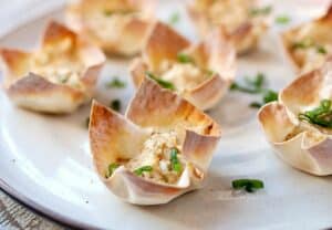 Hot Crab Dip Wonton Cups: These are the most addictive little bites you'll find on an appetizer table. Hot crab dip spiced with Old Bay seasoning, shallot, and just a dash of hot sauce. Baked right into a crispy wonton cup! | macheesmo.com
