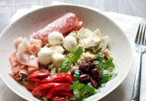 Antipasto Quinoa Bowls: Barely a recipe, this cross between a quinoa bowl and a traditional Italian Antipasto course has all of my favorite things. Of course, the nice thing about it is you can make it your own! Be sure to check out the recipe for my quinoa flavor BOOST trick! | macheesmo.com