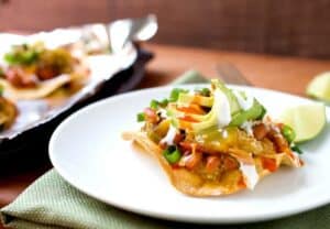 Chunky Tomatillo Tostadas: These crispy tostadas are topped with roasted tomatillos, pinto beans, queso fresco, and lots of other good toppings. Quick vegetarian Tex-mex dinner alert! | macheesmo.com