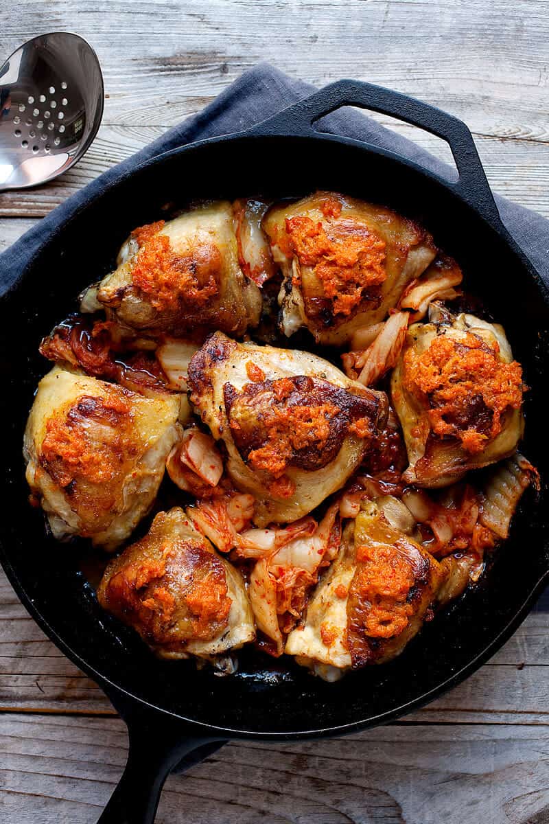 3 Ingredient Kimchi Chicken Thighs: These crispy chicken thighs are slow roasted with just two other ingredients! You won't believe the flavor they have though thanks to spicy, fermented kimchi. Spicy comfort food at its best! | macheesmo.com
