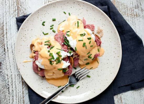 Reuben Eggs Benedict: Easy St. Patrick's Day brunch with rye bread, corned beef, sauerkraut, a quick Thousand Island Hollandaise sauce and perfectly poached eggs. So good and a great starter eggs benedict. Easy to make! | macheesmo.com 