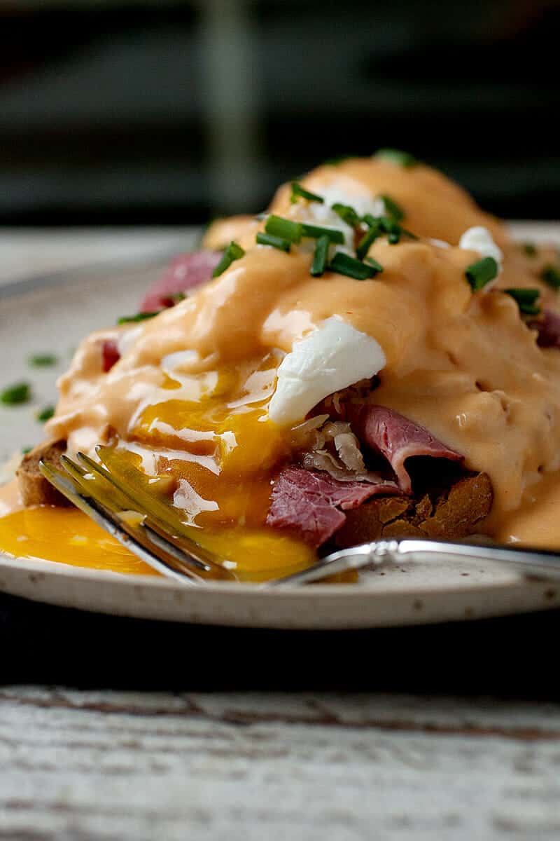 Reuben Eggs Benedict: Easy St. Patrick's Day brunch with rye bread, corned beef, sauerkraut, a quick Thousand Island Hollandaise sauce and perfectly poached eggs. So good and a great starter eggs benedict. Easy to make! | macheesmo.com 