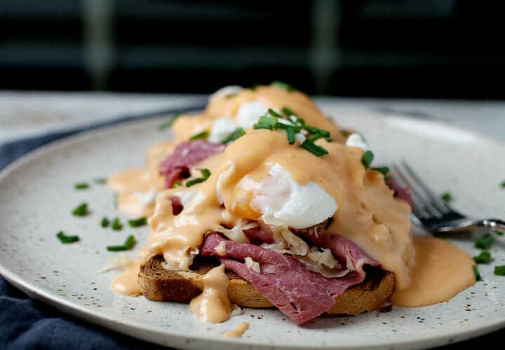 Reuben Eggs Benedict: Easy St. Patrick's Day brunch with rye bread, corned beef, sauerkraut, a quick Thousand Island Hollandaise sauce and perfectly poached eggs. So good and a great starter eggs benedict. Easy to make! | macheesmo.com