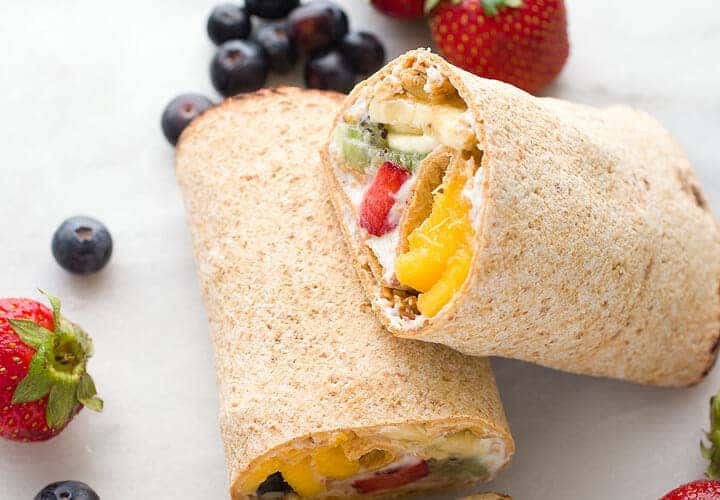 Rainbow Breakfast Wraps: These quick wraps are so quick to make an a perfect way to start the day. Packed with granola, Greek yogurt, and colorful fruits and stuffed inside a flatbread. #sponsored | macheesmo.com