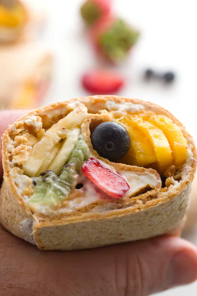 Rainbow Breakfast Wraps: 🌈 These quick wraps are so quick to make an a perfect way to start the day. Packed with granola, Greek yogurt, and colorful fruits and stuffed inside a flatbread. #sponsored | macheesmo.com