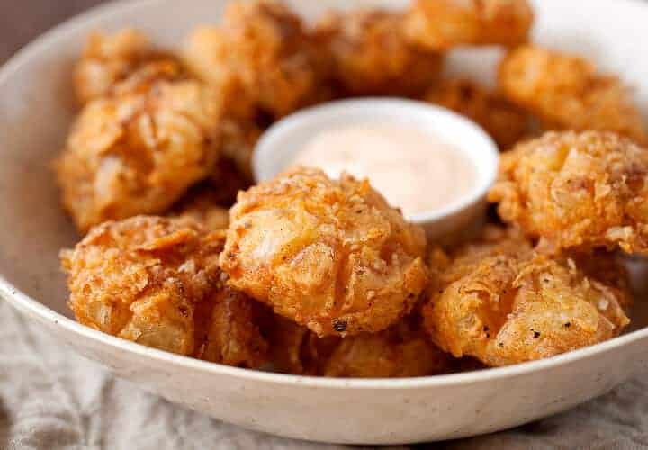 Bited Sized Blooming Onions: The perfect bite-sized version of the popular fried onion appetizer! Easy to share and easy to eat! So delicious and crispy with a soft slightly sweet and tangy bite. So good! | macheesmo.com