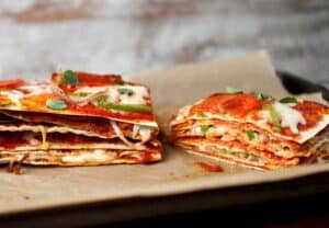 Pepperoni Pizza Stack: The key to this beautiful and delicious creature is to use thin crusts so the finished stack isn't too dough-filled! Layers of cheese, pepperoni, peppers, and onions makes for one delicious stack. I like to use Flatout Flatbread Artisan Thin Crust Pizza Crusts for my layers! #sponsored | macheesmo.com