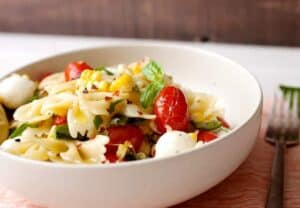 Grilled Tomato and Corn Pasta Salad: A perfect summer pasta salad with blistered grape tomatoes, charred sweet corn, and fresh mozzarella balls. Make it as a light summer dinner, weekday lunches, or it's perfect for an afternoon picnic! | macheesmo.com