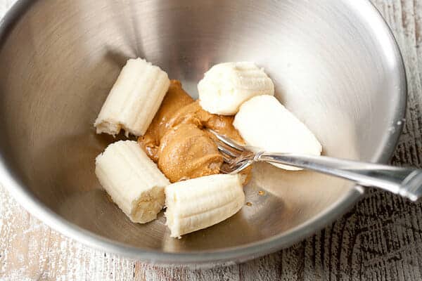 Bananas and peanut butter in a bowl.
