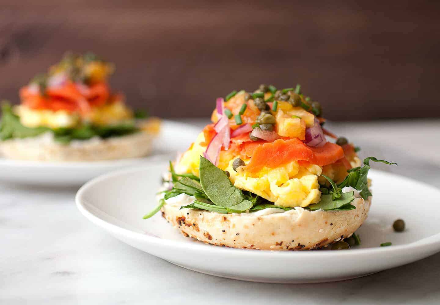 Mile High Open-Faced Bagels: These stacked beauties are too big to sandwich! You have to just build them on half a bagel due to all the wonderful toppings. Also, they can be ready to eat in literally 10 minutes. So fast and perfect for a surprisingly light and delicious breakfast or brunch. | macheesmo.com