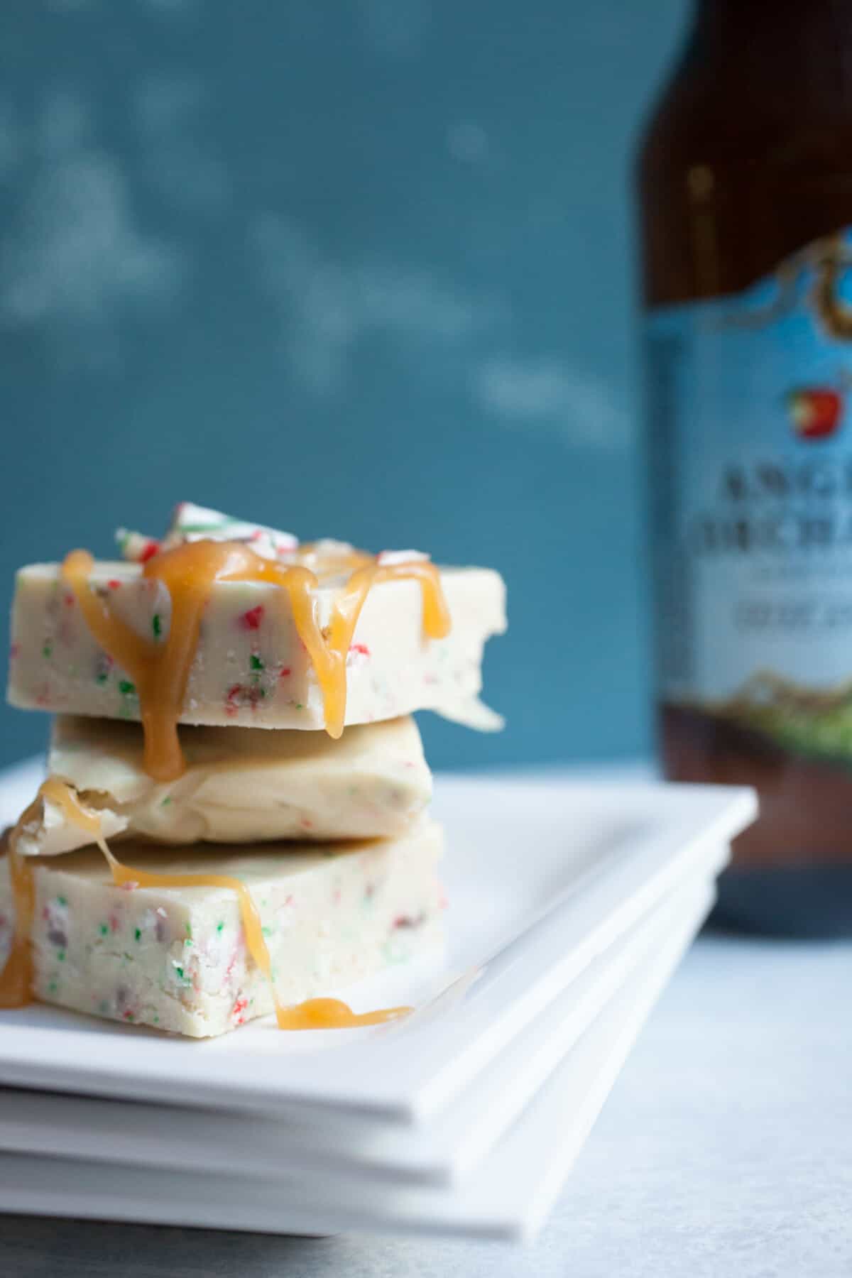 Hard Cider White Peppermint Fudge: This easy holiday fudge starts with reduced Angry Orchard Hard Cider. Plus, I like to top mine with a drizzle of Fireball Whisky caramel! YUM. | macheesmo.com