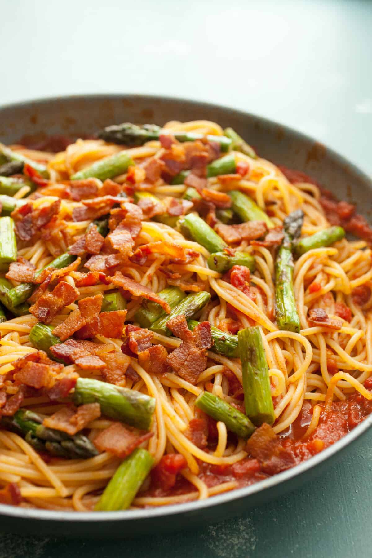 Bacon Asparagus Spaghetti: Perfect spring asparagus cooked with bacon a homemade tomato sauce and tossed with spaghetti! I love this Italian recipe! | macheesmo.com