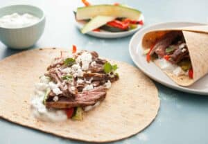 Grilled Greek Steak Wraps: Marinated and grilled skirt steak with loads of grilled veggies and a quick tzatziki sauce. A hearty and delicious wrap! | macheesmo.com