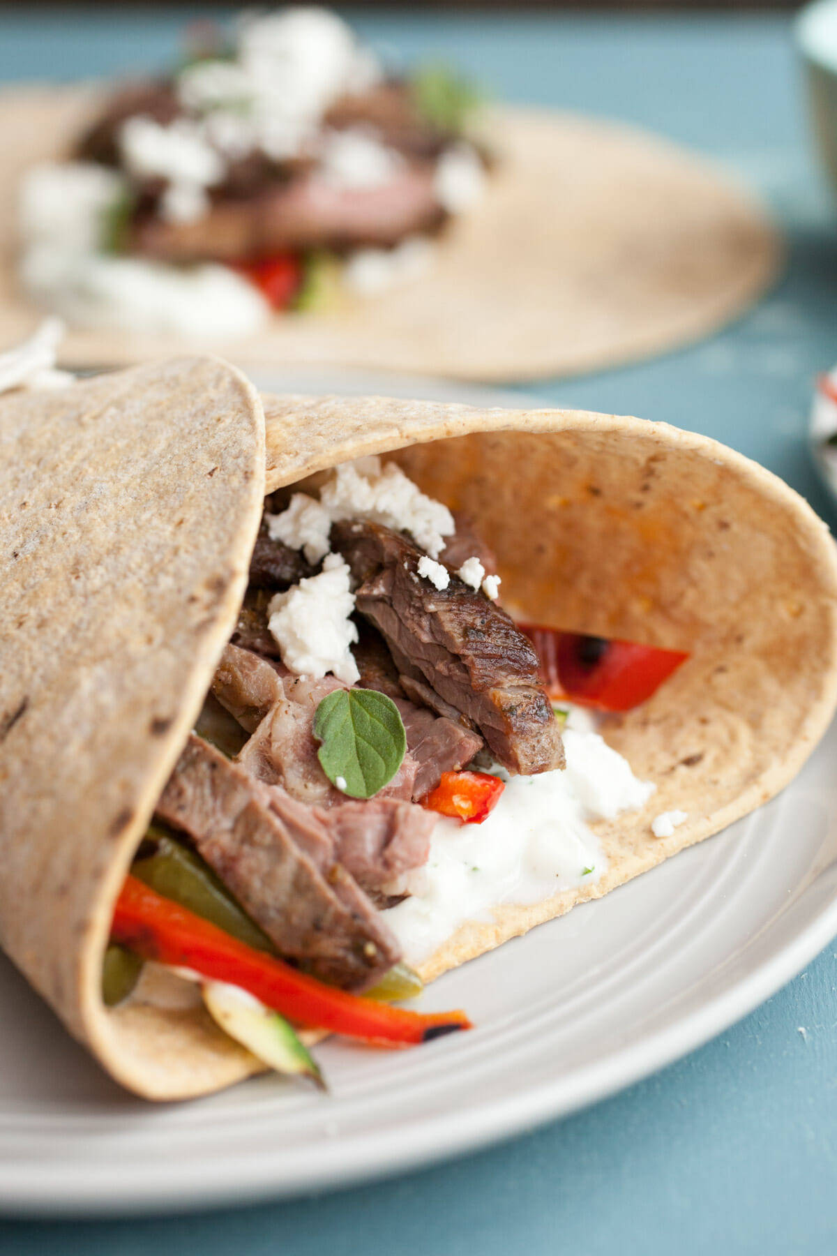 Grilled Greek Steak Wraps: Marinated and grilled skirt steak with loads of grilled veggies and a quick tzatziki sauce. A hearty and delicious wrap! | macheesmo.com
