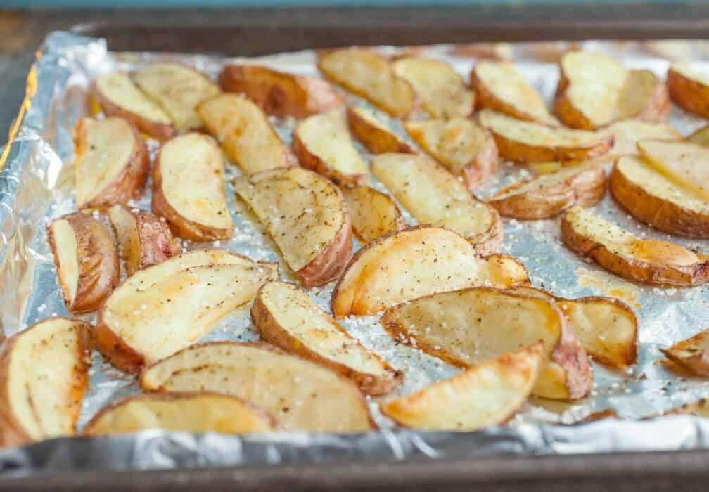 Salt and Vinegar Potato Wedges: The most addictive potato wedges out there. Easy to bake and even easier to eat. Roast them in the oven or toss them on a grill! | macheesmo.com