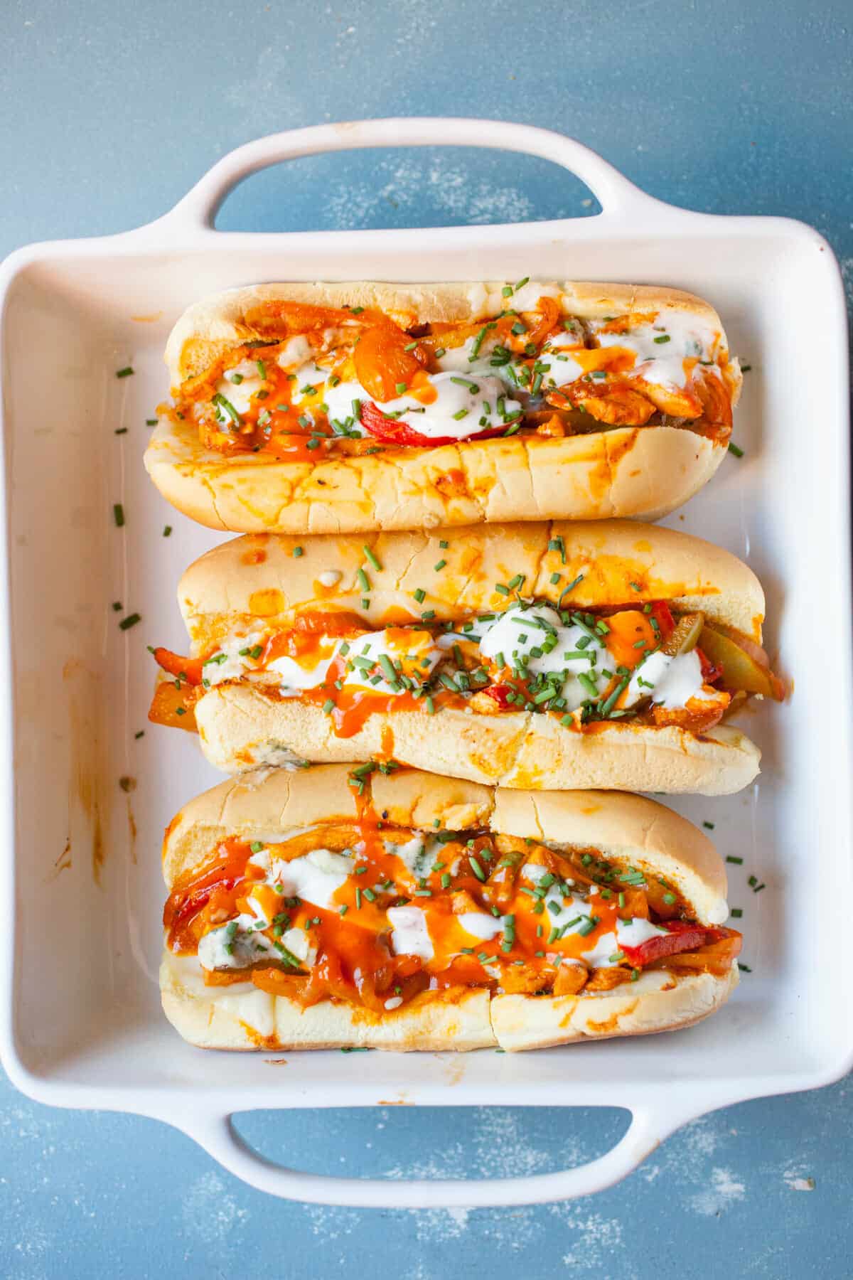 Baked Buffalo Chicken Subs: These have some of my favorite flavors and are easy to toss together either for dinner or for a hearty game day appetizer. Spicy and cheesy! | Macheesmo.com