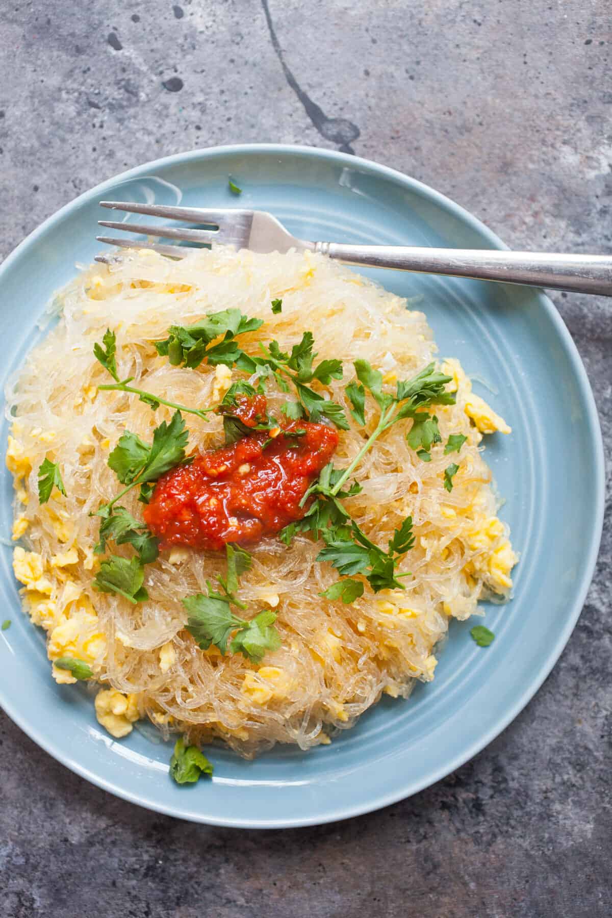 Glass Noodles stir-fried with eggs with parsley and chili sauce.