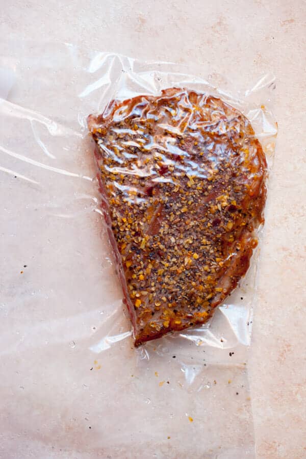 Flank steak sealed in a bag for sous vide cooking.