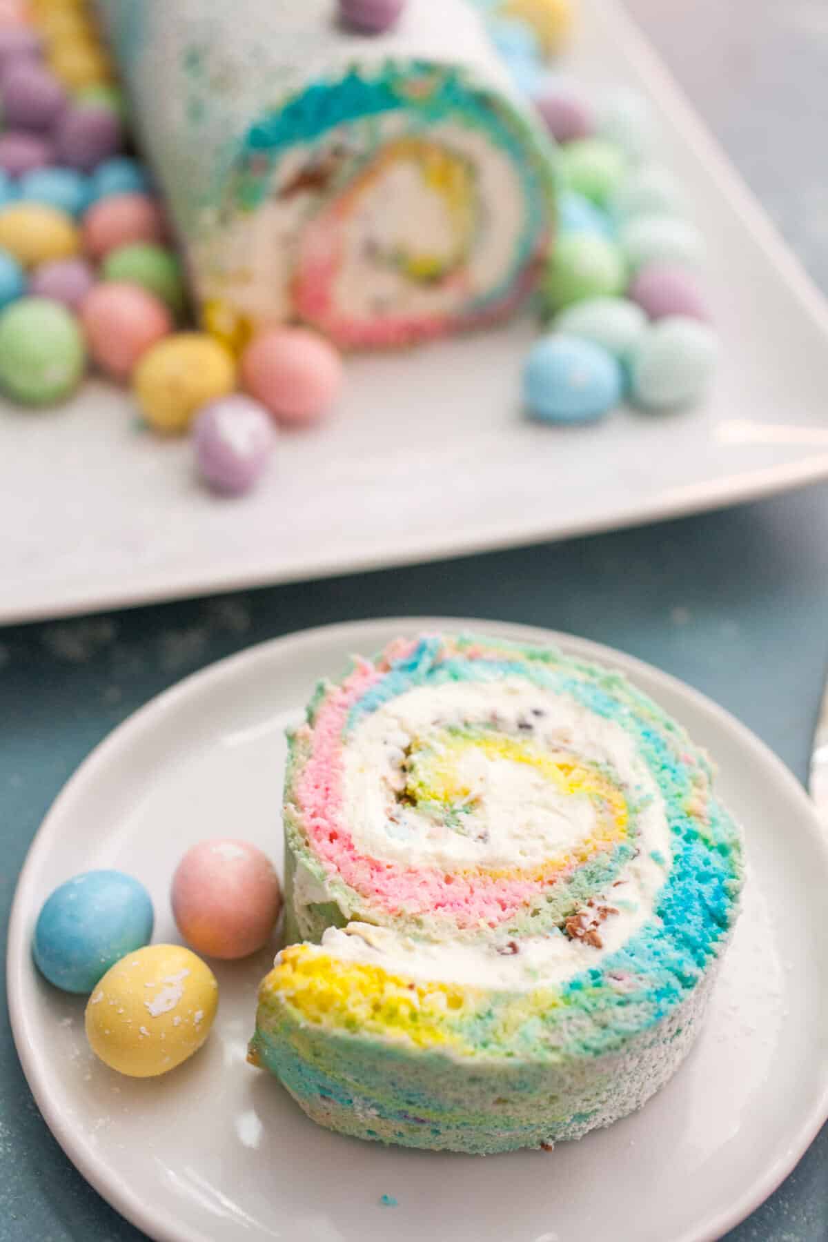 Easter Swiss Roll: A simple and colorful swiss roll filled with crushed candies and a cream cheese frosting. Perfect for Easter! | macheesmo.com