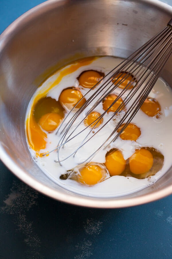 Whisking eggs with milk for sheet pan cooking
