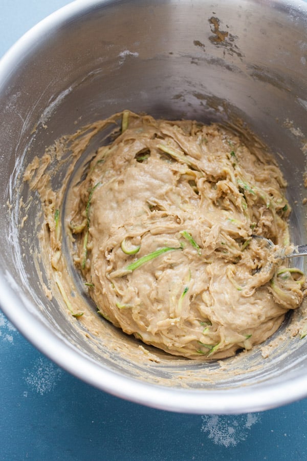 Batter for zucchini muffins in a bowl.