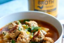 Homemade chicken meatballs are baked and simmered with broth, aromatics, and orzo to make this quick and perfect-for-winter soup. Yum! macheesmo.com #soup #chicken #meatball