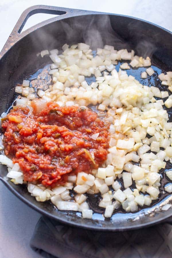 Base onions and salsa for cheesy beans.