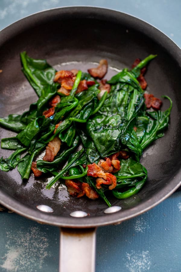 Wilted spinach in bacon grease for omelette filling.