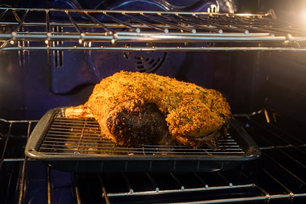 Roasting leg of lamb in the oven.