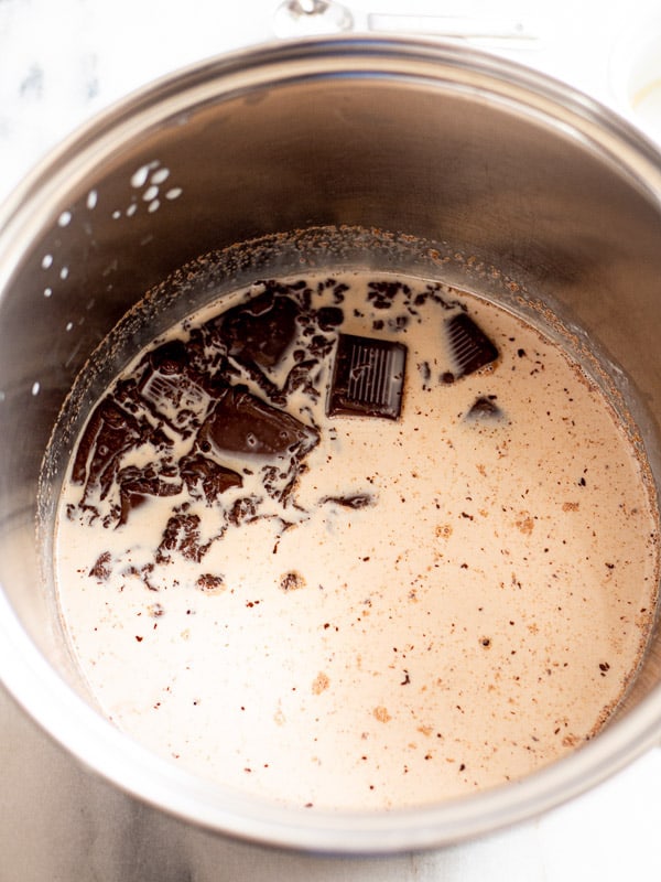 A saucepan with milk and melting chocolate