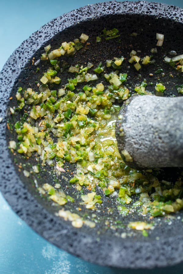 Making guacamole in a molcajete