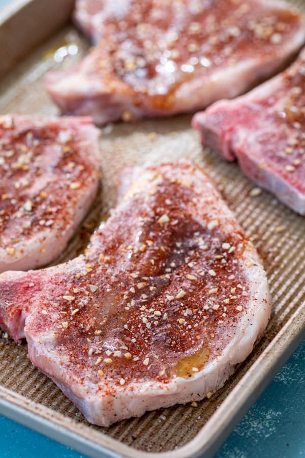 POrk chops ready to broil with spice mix.