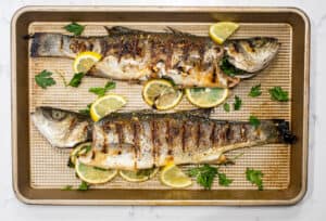 Grilled whole fish on baking sheet