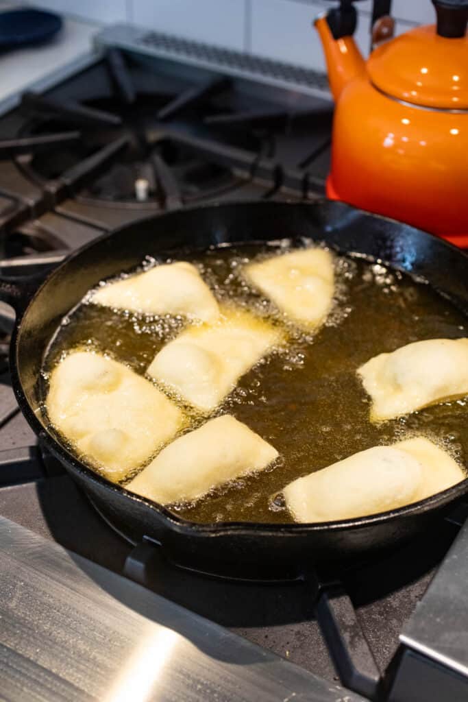 Frying the Sopapillas in a skillet.
